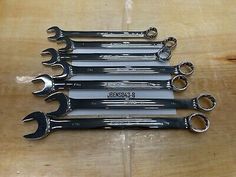 six wrenches are lined up on a table