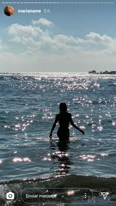 a person standing in the water with their arms outstretched