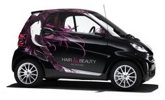 a smart car with an artistic design on the side