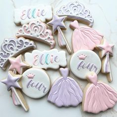 some decorated cookies are sitting on a counter top with the words, name and tiara