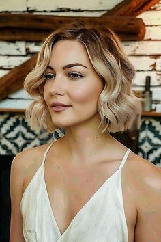 A woman with a layered bob featuring soft waves and a blend of honey and platinum highlights Short Wavy Bridal Hair, Wedding Hair For Short Fine Hair, Bob Hairstyle Formal Event, Bridal Hair For Shoulder Length Hair, Bob Hair Wedding Styles, Bob Haircut Wedding Hairstyles, Wavy Bob Wedding Hair, Wave Bob Hairstyles Short Wavy, Blonde Bob Bridal Hair