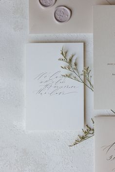 the wedding stationery is laid out on top of each other with wax stampers