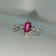 Band - rounak jewellers material - 925 sterling silver main stone - 100 %natural star ruby star ruby stone weight - 1.35 carat star ruby stone size - 5 x 7 mm secondary stone - cubic zirconia zirconia stone weight - 0.10 carat zirconia stone size - 1.20 mm gross weight - 2.320 gm stone shape - oval, round gem colour - red, white ring size - all size available please give your openion or feedback about the product. we accept bulk order also. Sterling Silver Cabochon Ruby Ring, Star Ruby Ring, Zirconia Rings, Rings Handmade, Star Ruby, Ruby Stone, Ring Minimalist, Cubic Zirconia Rings, Handmade Rings