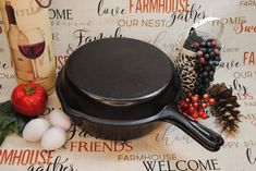 a cast iron skillet sitting on top of a table next to other kitchen items