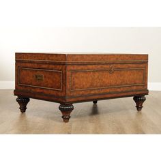 an old wooden chest sitting on top of a hard wood floor