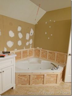 a bathroom with unfinished walls and a large jacuzzi tub