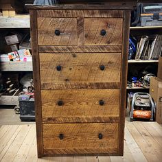 a wooden dresser sitting on top of a hard wood floor