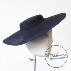 If sustainability and style are your thing, then look no further! These navy blue cartwheel hat bases are made from natural hemp braid sewn into the classic shape that has sprung into popularity in the past year.Ready to trim, they are fitted with a petersham ribbon on the inside crown edge. Simply add a comb or headband to secure to the head and your done!Hat base measures:Measures:Width: 35cm (13.7 inches)Crown height: 2.5cm (1 inch)For even more millinery supplies you can find us here:www.ets Fitted Navy Wide Brim Hat, Navy Fitted Wide Brim Hat, Fitted Flat Cap For Summer, Classic Navy Wide Brim Hat, Vintage Flat Cap Hats For Summer, Adjustable Wide Brim Navy Sun Hat, Adjustable Navy Wide Brim Sun Hat, Navy Adjustable Wide Brim Sun Hat, Navy Brimmed Hats For Beach