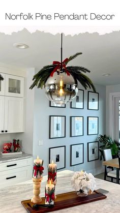 a kitchen island with candles and pictures on the wall behind it, in front of a dining room table