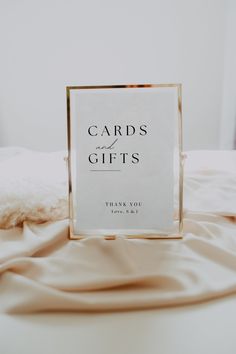 a card that is sitting on top of a bed with the words cards and gifts