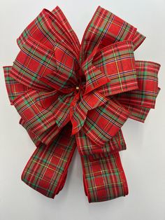 a red and green plaid bow on a white background