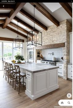 a large kitchen with an island in the middle and lots of counter space on one side