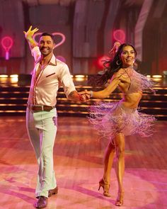 a man and woman dancing on the dance floor