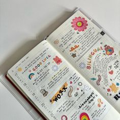 an open planner book with stickers on it