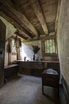 the interior of an old house with wood beams and stonework on the walls,