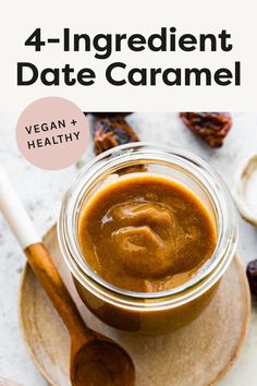 a jar filled with vegan and healthy date caramel sauce on top of a plate