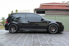 a black car parked in front of a house