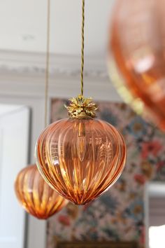 three hanging glass ornaments in a living room