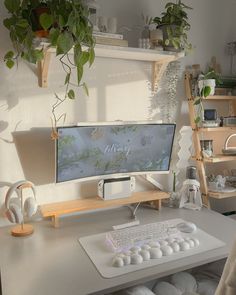 a computer monitor sitting on top of a white desk next to a keyboard and mouse