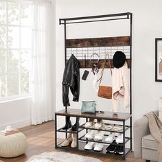 a coat rack with shoes, purses and hats hanging on it in a living room