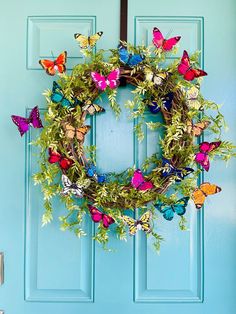 a blue door with a butterfly wreath on it