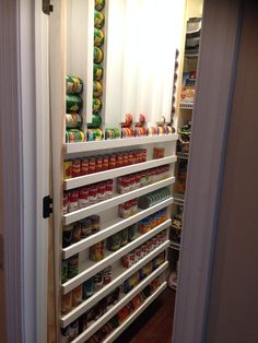 an open pantry door with canned food in it