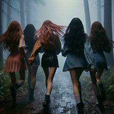 four girls walking in the woods on a foggy day with their backs turned to the camera