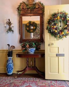 a door with a wreath on it next to a table