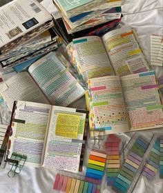 there are many books on the table with different colors and pages in each book,