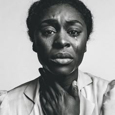 a black and white photo of a woman with her hands on her chest