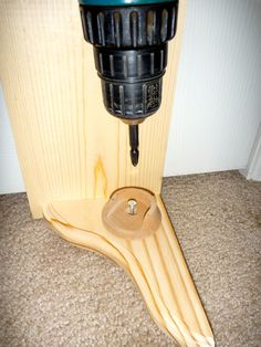 a drill is sitting on top of a piece of wood