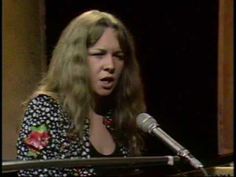 a woman standing in front of a microphone