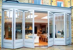 an open door leading into a living room and dining room with french doors on both sides