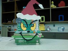 a stack of books sitting on top of a table next to a shelf filled with toys