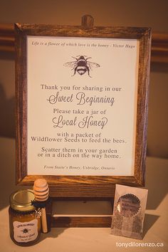 a honey jar and sign on a table