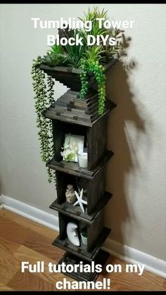 there is a tall wooden shelf with plants on it and the words tumbling tower block diys