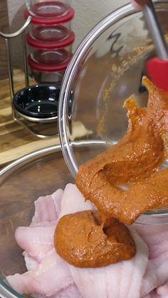 the food is being prepared and ready to be put into the bowl with tongs