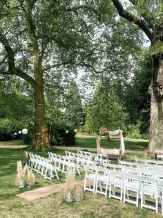 an outdoor wedding setup with white chairs