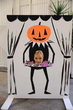 a painting of a child holding a plate with a pumpkin on it's face