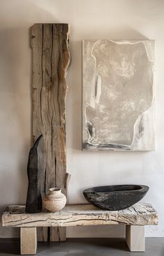 a large piece of wood sitting on top of a wooden bench next to a bowl