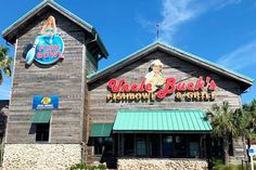 the front of a restaurant with a large sign on it's side and palm trees