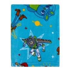 a blue blanket with an image of a cartoon character flying through the sky on it