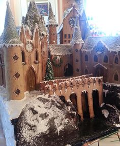 a gingerbread castle is on display in front of a window