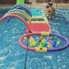 an inflatable pool filled with balls and water toys next to a child's swimming pool