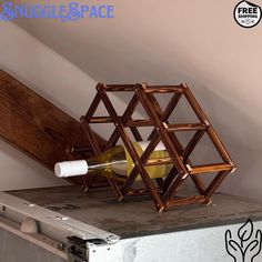 a wine bottle holder made out of bamboo sticks and other items sitting on top of a metal box