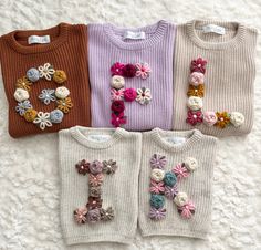 Custom Hand Embroidered Sweaters - Large Letter or Number MATERIALS/FIT: This set of hand embroidered sweaters are completely customizable and are available in several different colors. These sweaters have an oversized fit/feel and are a knit material, so they do have a stretch to them. See approximate measurements below:  Size/Length/Chest      * 0-3 M / 11 in / 12 in     * 3-6 M / 11.5 in / 13 in     * 6-9 M / 12 in / 13.75 in     * 9-12 M / 13 in / 14.5 in     * 12-18 M / 14.25 in / 15.5 in Initial Sweater, Small Business Clothing, Embroidered Sweaters, Hand Embroidered Name, Personalized Sweater, Custom Sweaters, Custom Baby Gifts, Floral Initial, Handmade Sweater