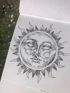 a drawing of the face of a sun with eyes drawn in black ink on white paper