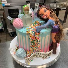 a barbie doll cake with sprinkles and confetti