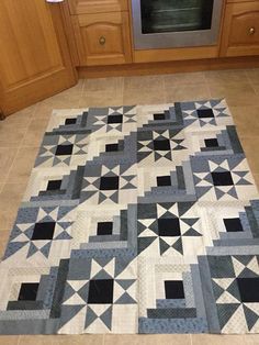 a kitchen area with a rug on the floor and oven in the backround