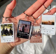 four different cell phones are being held in the palm of a person's hand